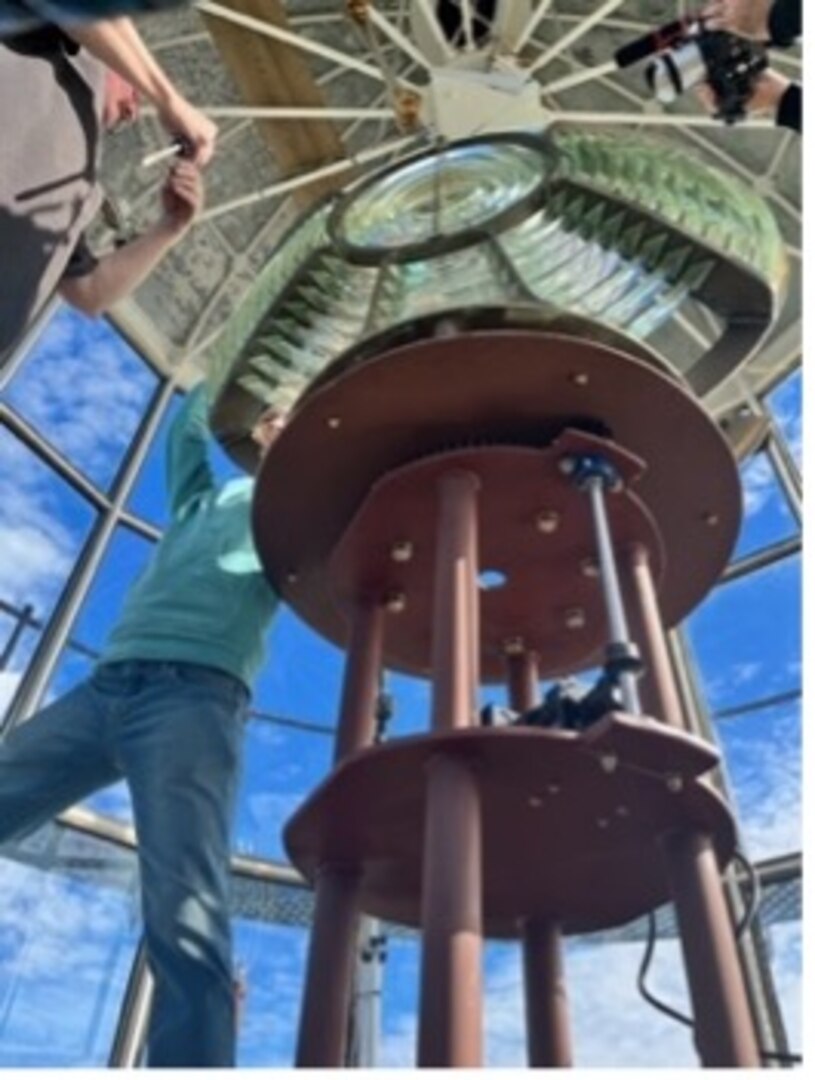 Workers install a Fresnel lens in the light room of the Montauk Lighthouse In Montauk New York. The 3 ½ Order Fresnel lens was created in France in 1903 and has been retrofitted to the Montauk Lighthouse as part of a historical project. (Photo courtesy of the Montauk Historical Society)
