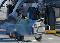 Airman 1st Class Seth Quillen, 5th Aircraft Maintenance Squadron crew chief, pushes a liquid oxygen (LOX) cart into position at Minot Air Force Base, North Dakota, Nov. 2, 2023. LOX carts allow Team Minot’s aircraft maintainers to transport LOX to the B-52H Stratofortress safely. (U.S. Air Force photo by Airman 1st Class Kyle Wilson)