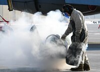 Airman 1st Class Seth Quillen, 5th Aircraft Maintenance Squadron crew chief, turns a nozzle on a liquid oxygen (LOX) cart at Minot Air Force Base, North Dakota, Nov. 2, 2023. LOX boils at minus 297 degrees Fahrenheit, which requires Airmen working with it to wear protective clothing to shield them from the freezing temperatures. (U.S. Air Force photo by Airman 1st Class Kyle Wilson)