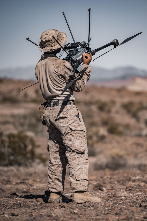U.S. Marine Corps Cpl. Jakob Santos, a Davie, Florida native, small unmanned aircraft systems operator with 3rd Battalion, 4th Marine Regiment (REIN), 7th Marine Regiment, inspects an R80D Skyraider drone during Exercise Apollo Shield at Marine Corps Air-Ground Combat Center, Twentynine Palms, California, Oct 19. 2023. Exercise Apollo Shield is the culminating event of Marine Corps Warfighting Lab’s 1-year crawl-walk-run bilateral effort to test equipment capabilities and evaluate tactics, techniques, and procedures. The Combat Center provides a training facility capable of truly testing the equipment and it is home to the infantry battalion experiment 2030, the first unit to receive the equipment tested by MCWL. (U.S. Marine Corps photo by Lance Cpl. Justin J. Marty)