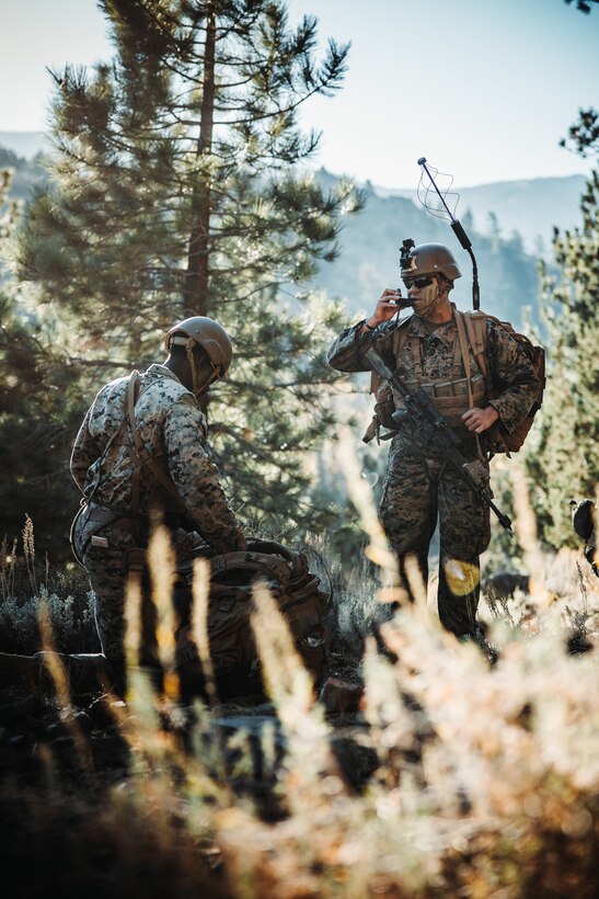 U.S. Marine Corps Sgt. Dante Beckett, a transmissions system operator, left, and Lance Cpl. Dominic Soto, a Chicago, Illinois native, intelligence specialist, both with 2nd Battalion, 5th Marine Regiment, 1st Marine Division, conduct a radio check during a simulated cliff assault as part of Mountain Exercise 1-24 at Marine Corps Mountain Warfare Training Center, Bridgeport, California, Oct. 20, 2023. MCMWTC specializes in mountain warfare training, providing a unique and ideal opportunity to rehearse operations in a mountainous environment. (U.S. Marine Corps photo by Lance Cpl. Richard PerezGarcia)