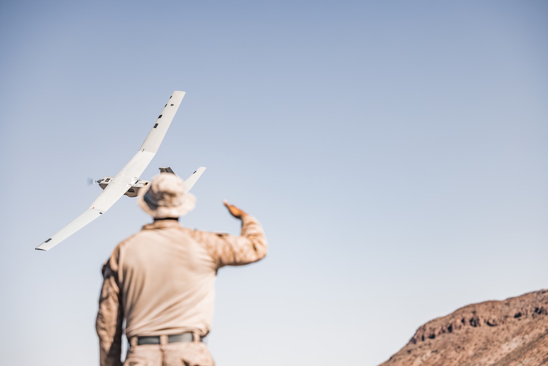 U.S. Marine Corps Cpl. Cameron Lewis, a Mechanicsville, Virginia native, small unmanned aircraft systems operator with 3rd Battalion, 4th Marine Regiment (REIN), 7th Marine Regiment, launches an RQ-20B Puma small unmanned aircraft during Exercise Apollo Shield at Marine Corps Air-Ground Combat Center, Twentynine Palms, California, Oct 19. 2023. Exercise Apollo Shield is the culminating event of Marine Corps Warfighting Lab’s 1-year crawl-walk-run bilateral effort to test equipment capabilities and evaluate tactics, techniques, and procedures. The Combat Center provides a training facility capable of truly testing the equipment and it is home to the infantry battalion experiment 2030, the first unit to receive the equipment tested by MCWL. (U.S. Marine Corps photo by Lance Cpl. Justin J. Marty)