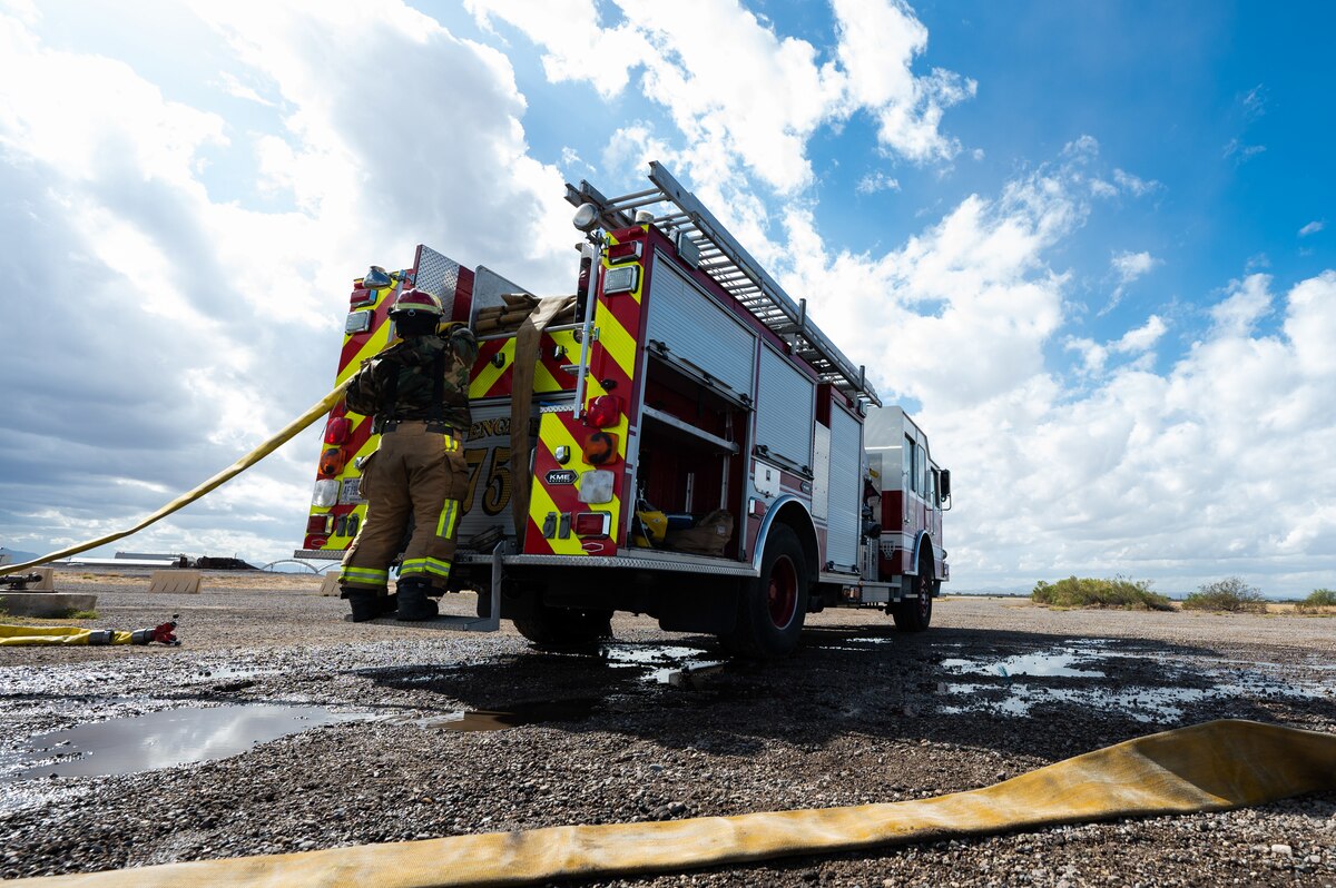 U.S. Air Force Tech. Sgt. Brian Davenport, 355th Civil Engineer Squadron firefighter, puts away a firehose at Davis-Monthan Air Force Base, Ariz., Oct. 24, 2023. Fire protection Airmen completed training exercises, including structural fire and A-10 pilot egress scenarios, reinforcing their skills in firefighting operations and victim extrication. (U.S. Air Force photo by Airman 1st Class Jasmyne Bridgers-Matos)