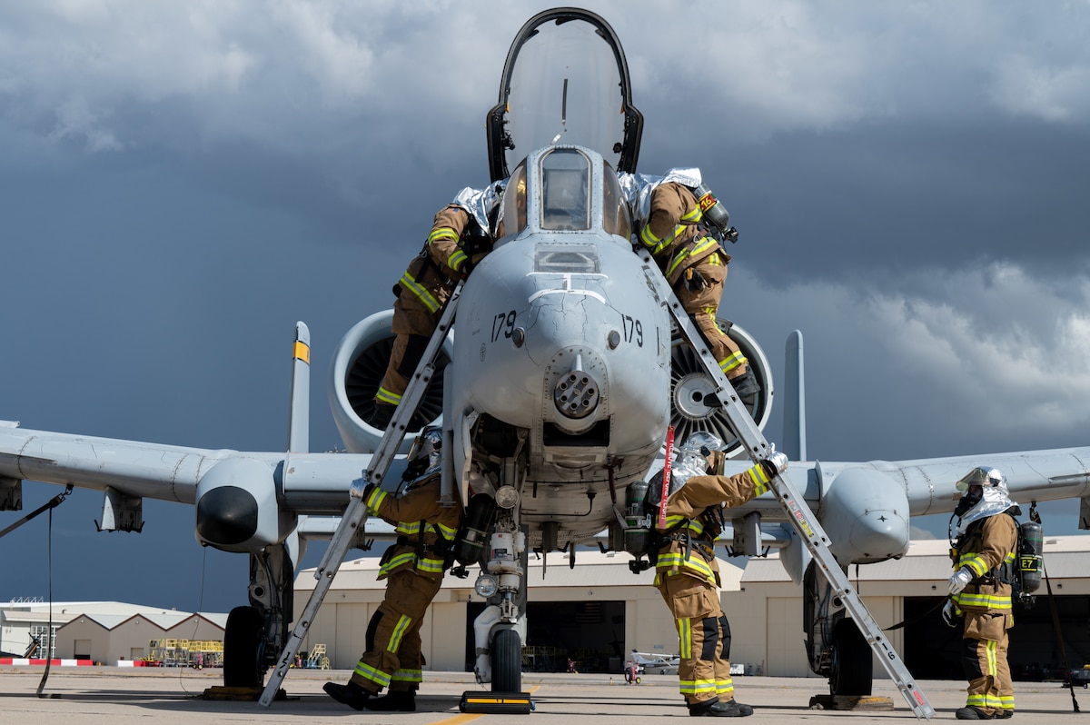 Airmen assigned to the 355th Civil Engineer Squadron respond to a simulated A-10 egress at Davis-Monthan Air Force Base, Ariz., Oct. 24, 2023. The A-10 egress sharpened their skills in egressing a pilot from an aircraft that could be experiencing any number of issues. (U.S. Air Force photo by Airman 1st Class Jasmyne Bridgers-Matos)