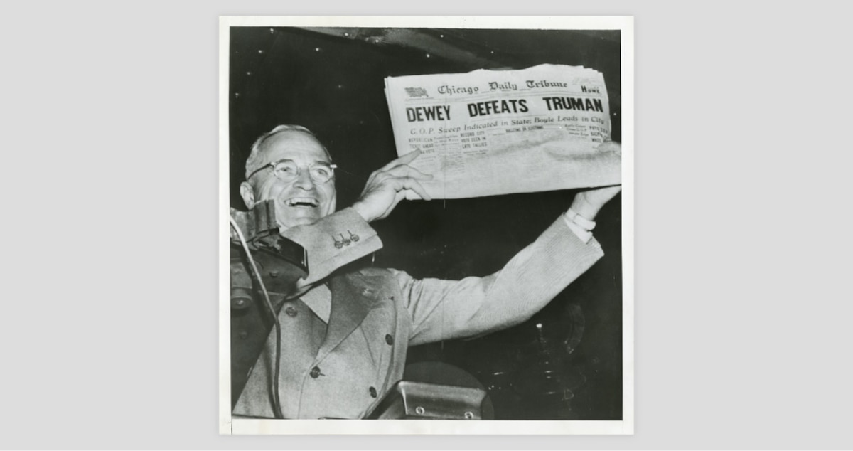 Photograph of President Harry S. Truman holding up a copy of the Chicago Daily Tribune with a front-page headline that reads, "DEWEY DEFEATS TRUMAN."