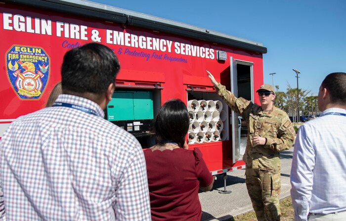 An Airman shows to a crowd the Eglin Fire and Emergency Services Specialized Mobile Advanced Rehab Technologies Trailer.
