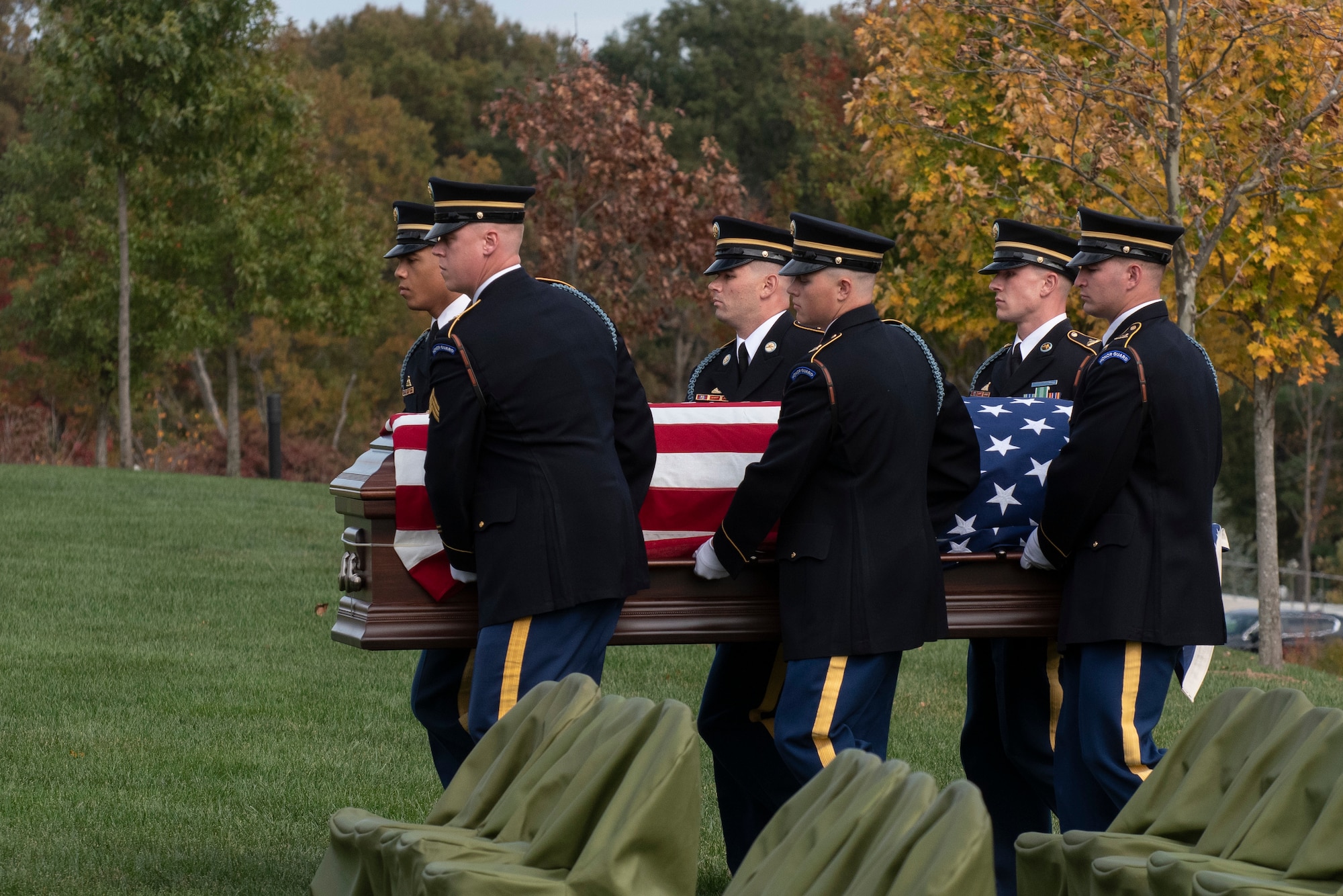 Honor guardsmen carry a casket.