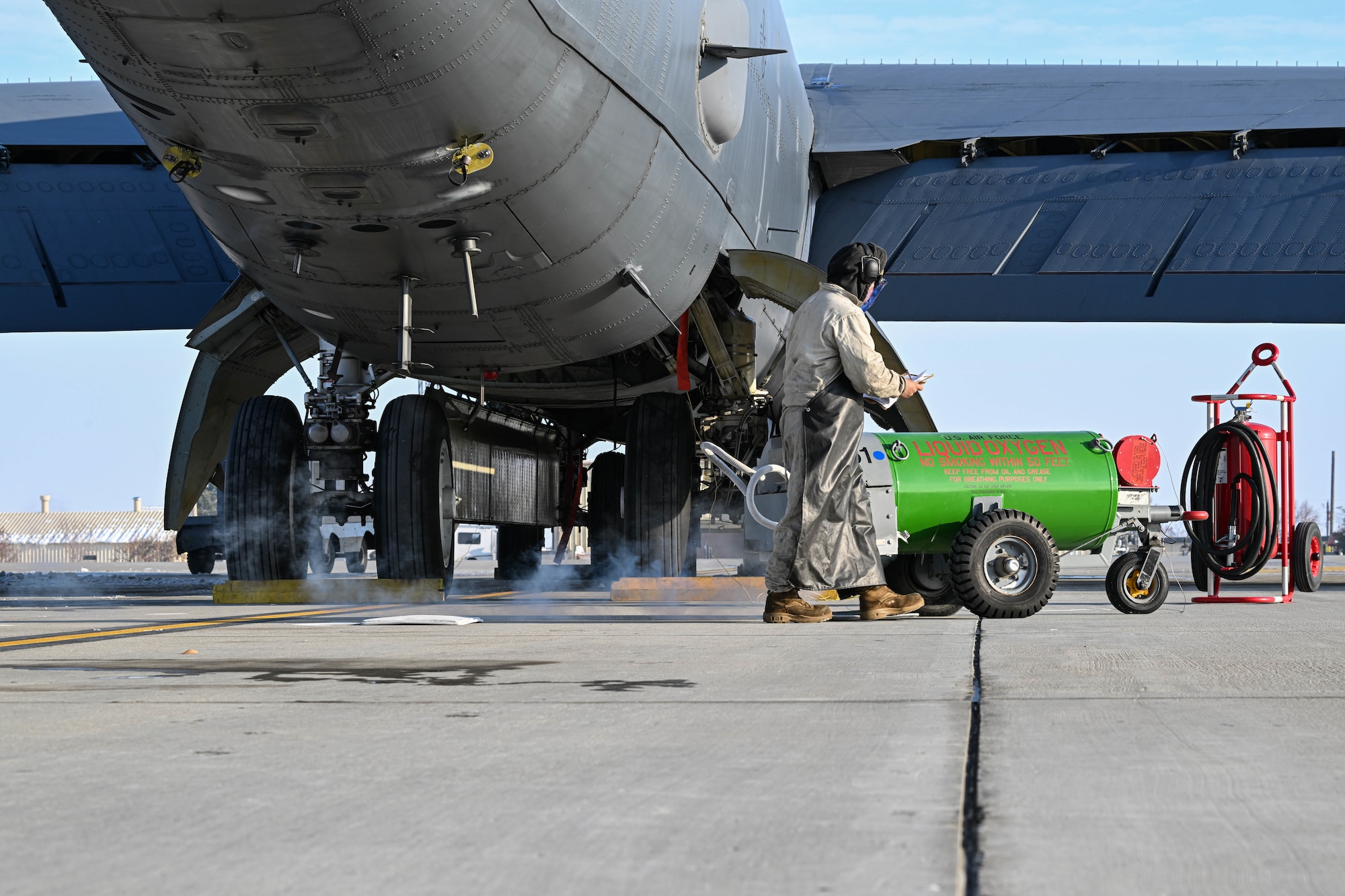 Airman 1st Class Seth Quillen, 5th Aircraft Maintenance Squadron crew chief, looks at his checklist while performing liquid oxygen (LOX) maintenance on a B-52H Stratofortress at Minot Air Force Base, North Dakota, Nov. 2, 2023. Crew chiefs regularly perform LOX maintenance on aircraft to ensure pilots and aircrew have oxygen readily available during flight. (U.S. Air Force photo by Airman 1st Class Kyle Wilson)