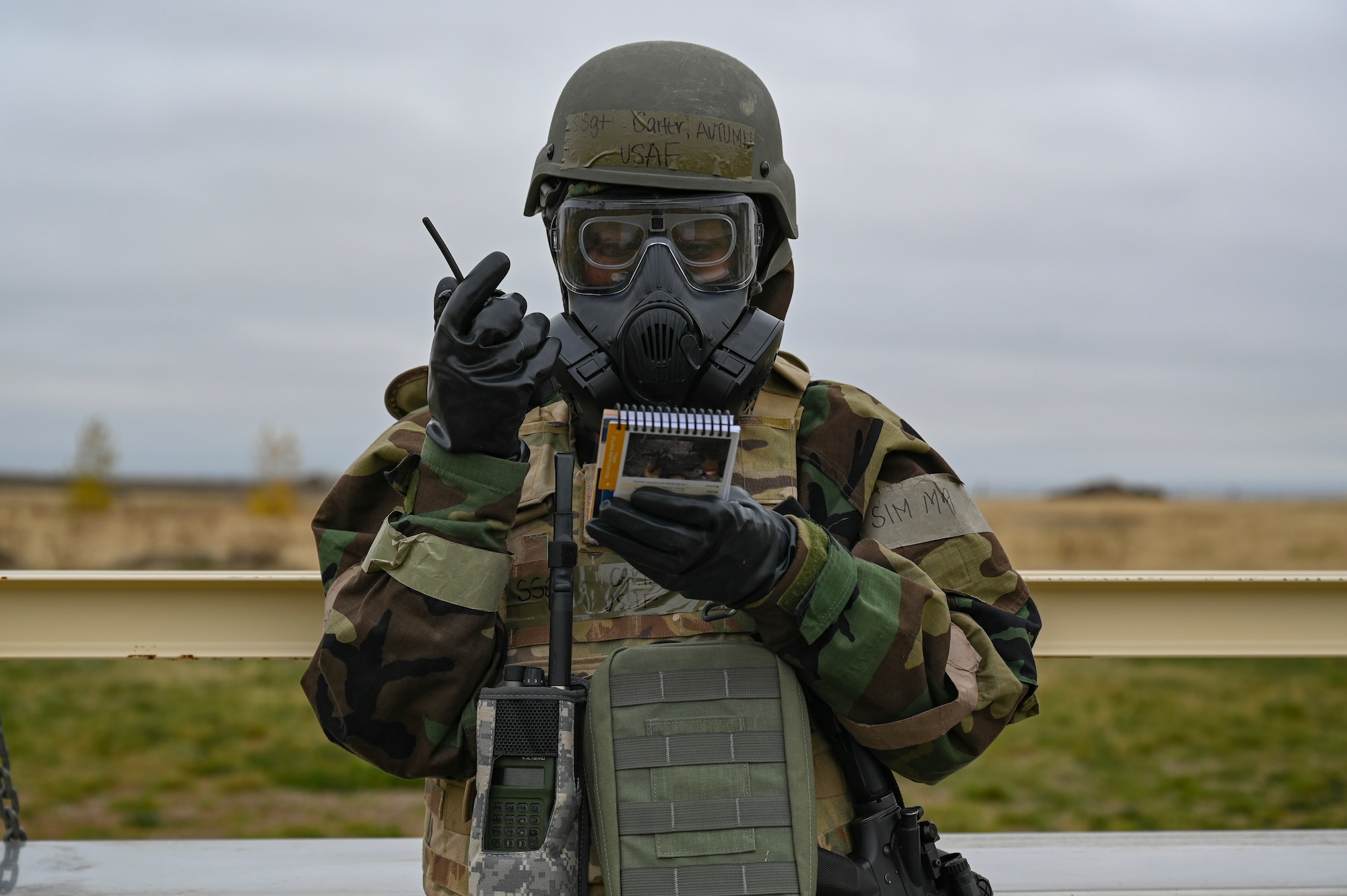An Airman talks to a radio.