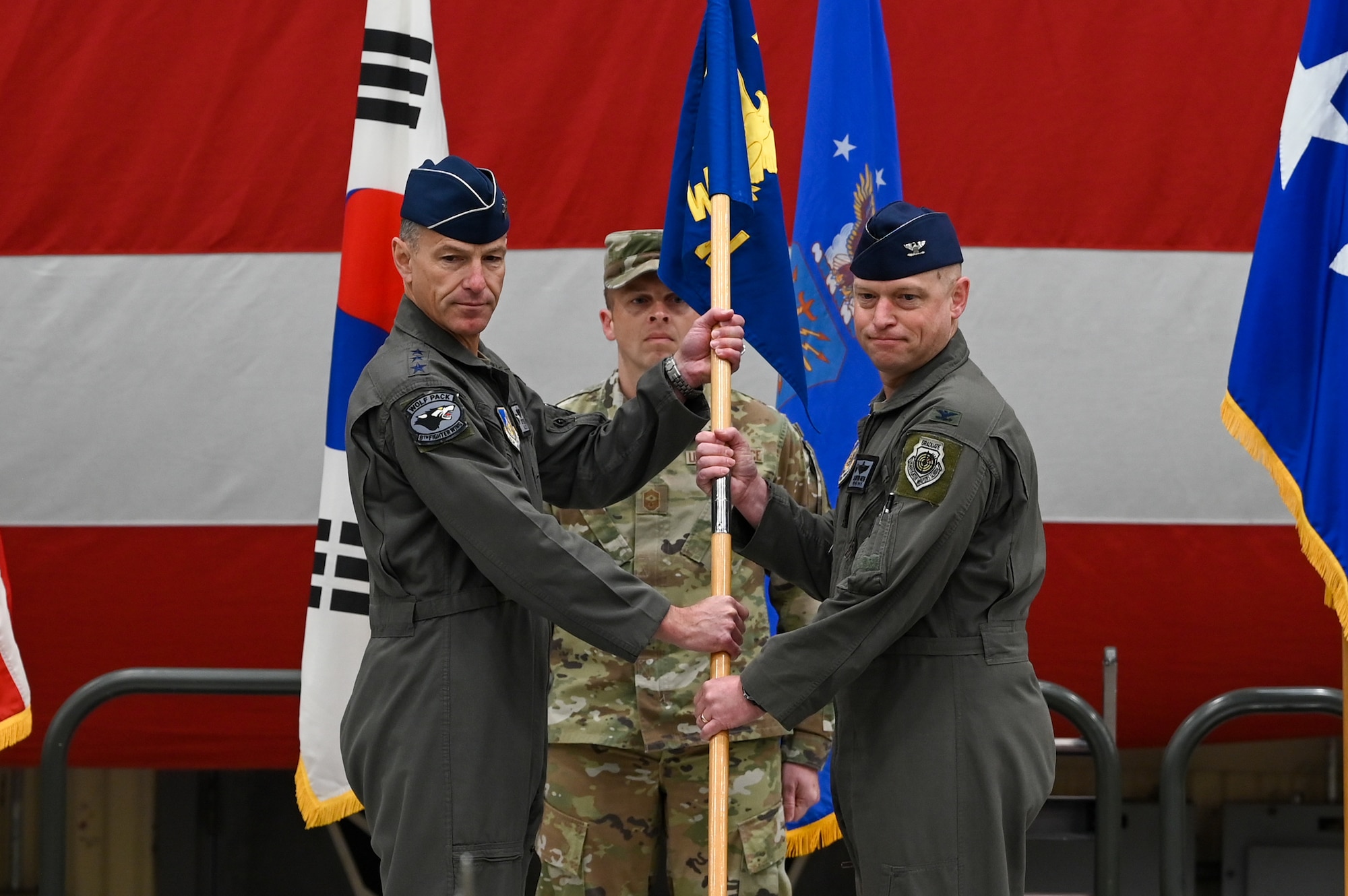 Lt. Gen. Scott Pleus gives the 8th Fighter Wing guidon to Col. Matthew C. Gaetke during the 8th FW Assumption of Command ceremony.