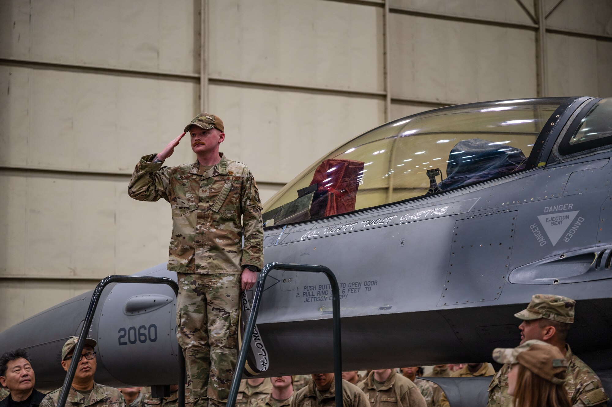 Staff Sgt. Michel Batchelor renders a salute to Col. Matthew C. Gaetke after unveiling Gaetke’s name on the wing’s heritage F-16 Fighting Falcon during the 8th FW Assumption of Command ceremony.