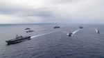 PHILIPPINE SEA (Nov. 7, 2023) Nimitz-class aircraft carriers, USS Ronald Reagan (CVN 76) and USS Carl Vinson (CVN 70), steam in formation with Japan Maritime Self-Defense Force (JMSDF) first-in-class helicopter destroyer, JS Hyuga (DDH 181), Ticonderoga-class guided-missile cruisers, USS Antietam (CG 54) and USS Robert Smalls (CG 62), and Arleigh Burke-class guided-missile destroyers, USS Sterett (DDG 104) and USS Kidd (DDG 100), during the Multi-Large Deck Exercise (MLDE) in the Philippine Sea, Nov. 7. Ronald Reagan is participating in the bilateral MLDE, which features the ships and aircraft of JMSDF Escort Flotilla 3, as well as the U.S. Navy’s Carrier Strike Group 1 and Carrier Strike Group 5. MLDE is a multi-domain event that grows the already strong partnership and interoperability that exists between the JMSDF and U.S. Navy today. (U.S. Navy photo by Mass Communication Specialist 3rd Class Timothy Dimal)