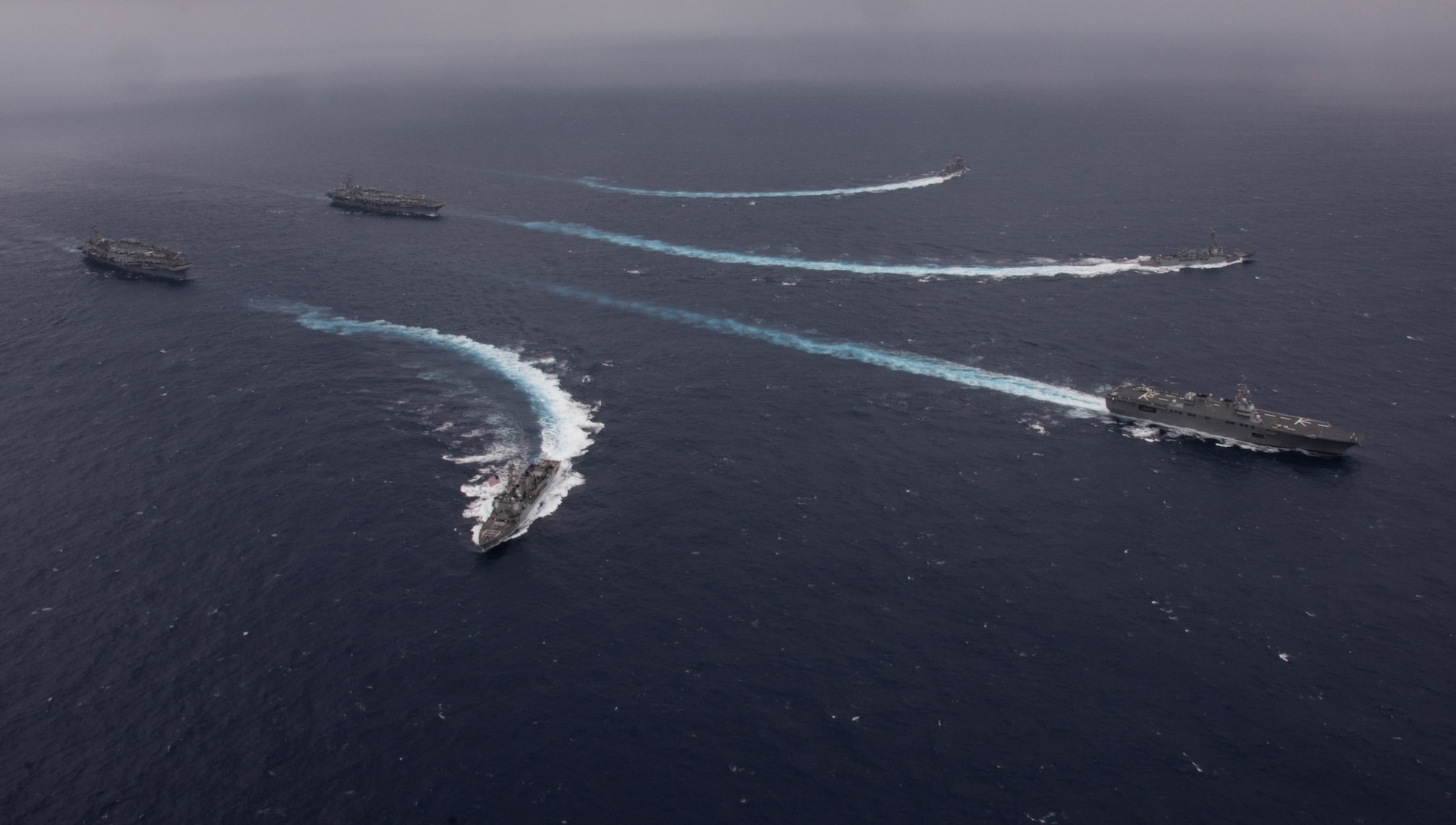 USS Ronald Reagan (CVN 76), back top, and USS Carl Vinson (CVN 70) steam in formation with the Japan Maritime Self-Defense Force.