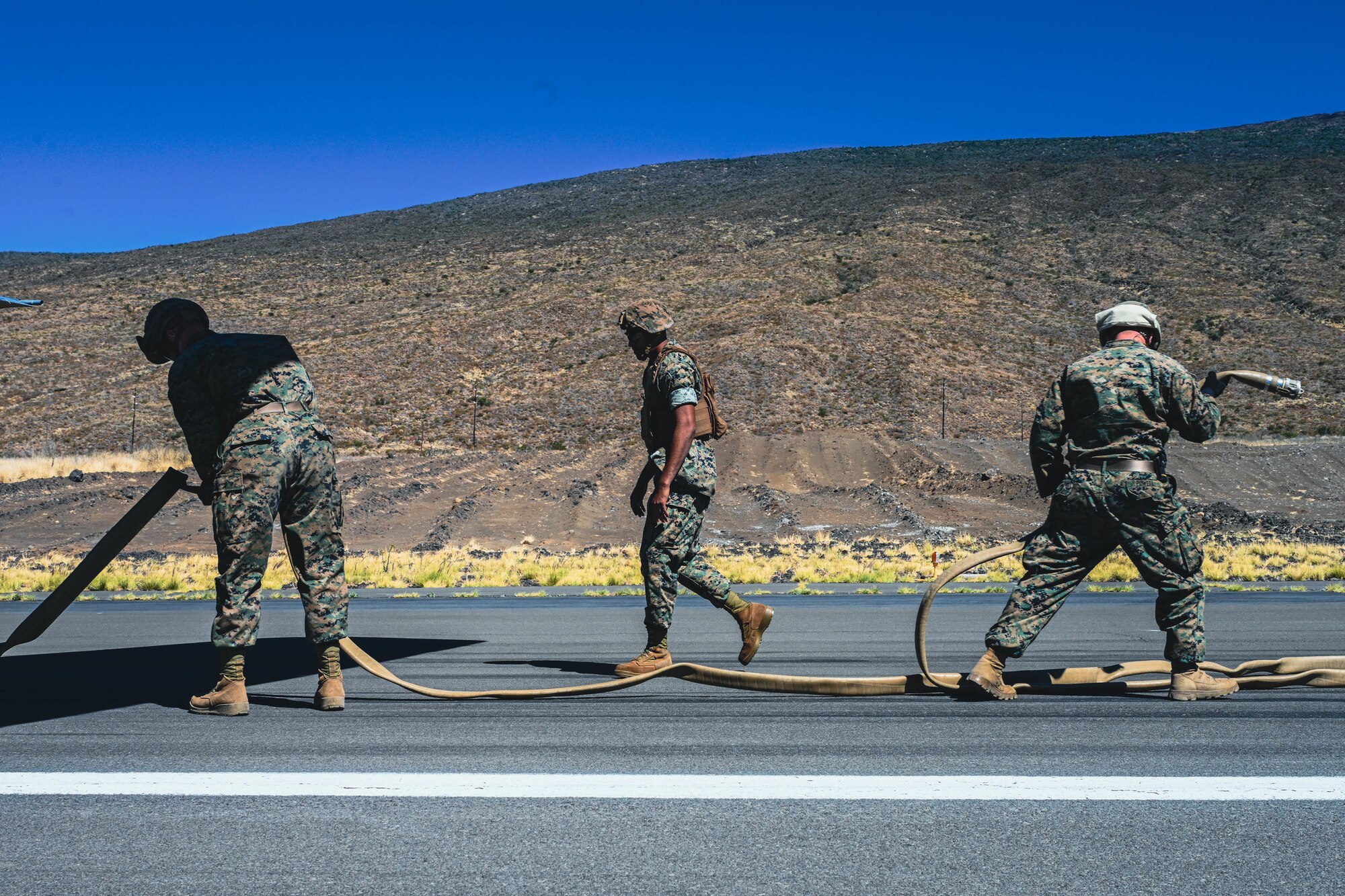 U.S. Marines maneuver a hose while conducting Forward Area Refueling Point operations.