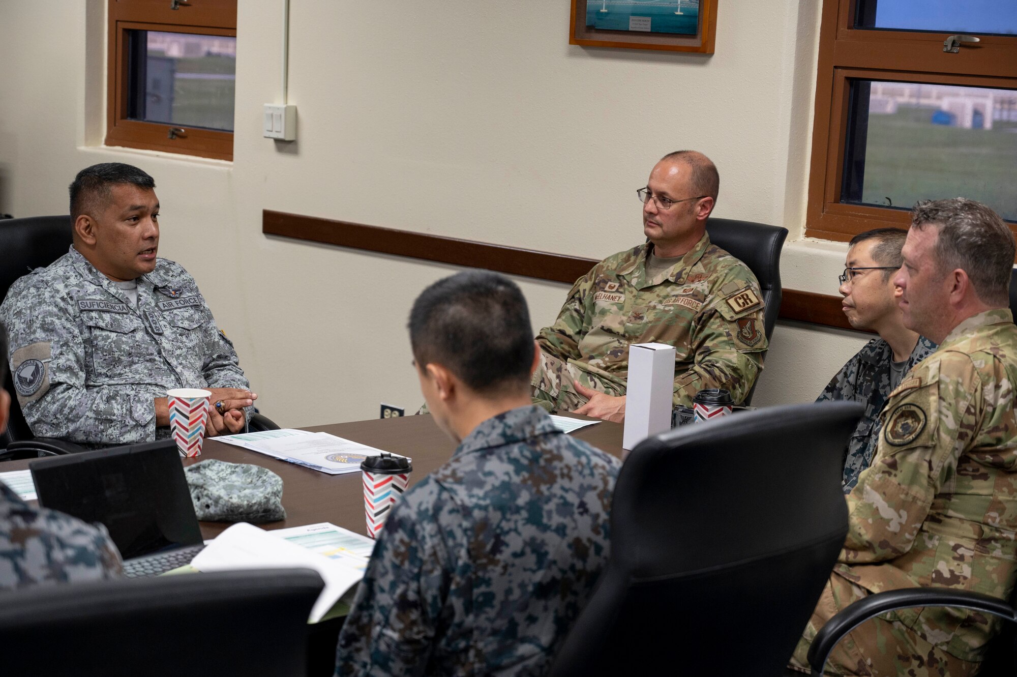 U.S. Air Force, Philippine Air Force and Japan Air Self-Defense Force leaders have a discussion at Andersen Air Force Base, Guam, Nov. 2, 2023. The 36th Contingency Response Group and the 36th Tactical Advisory Squadron hosted a trilateral discussion to facilitate discussions on regional security concerns, humanitarian aid and disaster relief, exercises, and operations. (U.S. Air Force photo by Senior Airman Emily Saxton)