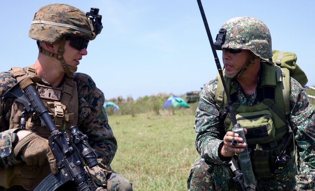 U.S. Marine 1st Lt. Benjamin Radeff with Echo Company, 2nd Battalion, 5th Marines and Philippine Marine 1st Lt Barahama talk about the next objective during an amphibious landing as part of KAMANDAG 2 in Naval Education Training Command, Philippines, Oct. 6, 2018. KAMANDAG helps maintain a high level of readiness and enhances bilateral military-to-military relations and capabilities. (U.S. Marine corps photo by Lance Cpl. Christine Phelps)