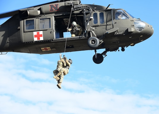 Airman 1st Class Bridger Michaud, 55th Operations Support Squadron survival, evasion, resistance and escape specialist, is hoisted into a Nebraska Army National Guard UH-60 Black Hawk helicopter along with a medic during hoist training Nov. 4, 2023. 