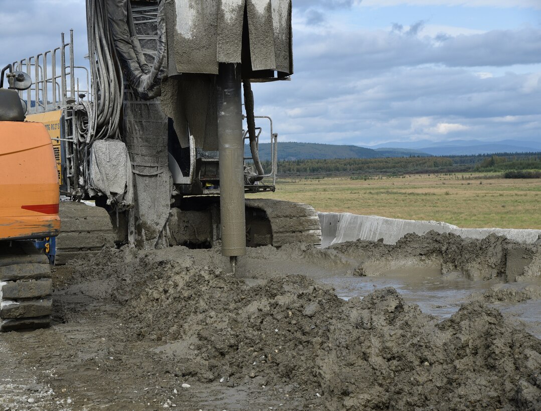 An auger digs into the top of Moose Creek Dam during a modification project at the Chena River Lakes Flood Control Project in North Pole, Alaska.