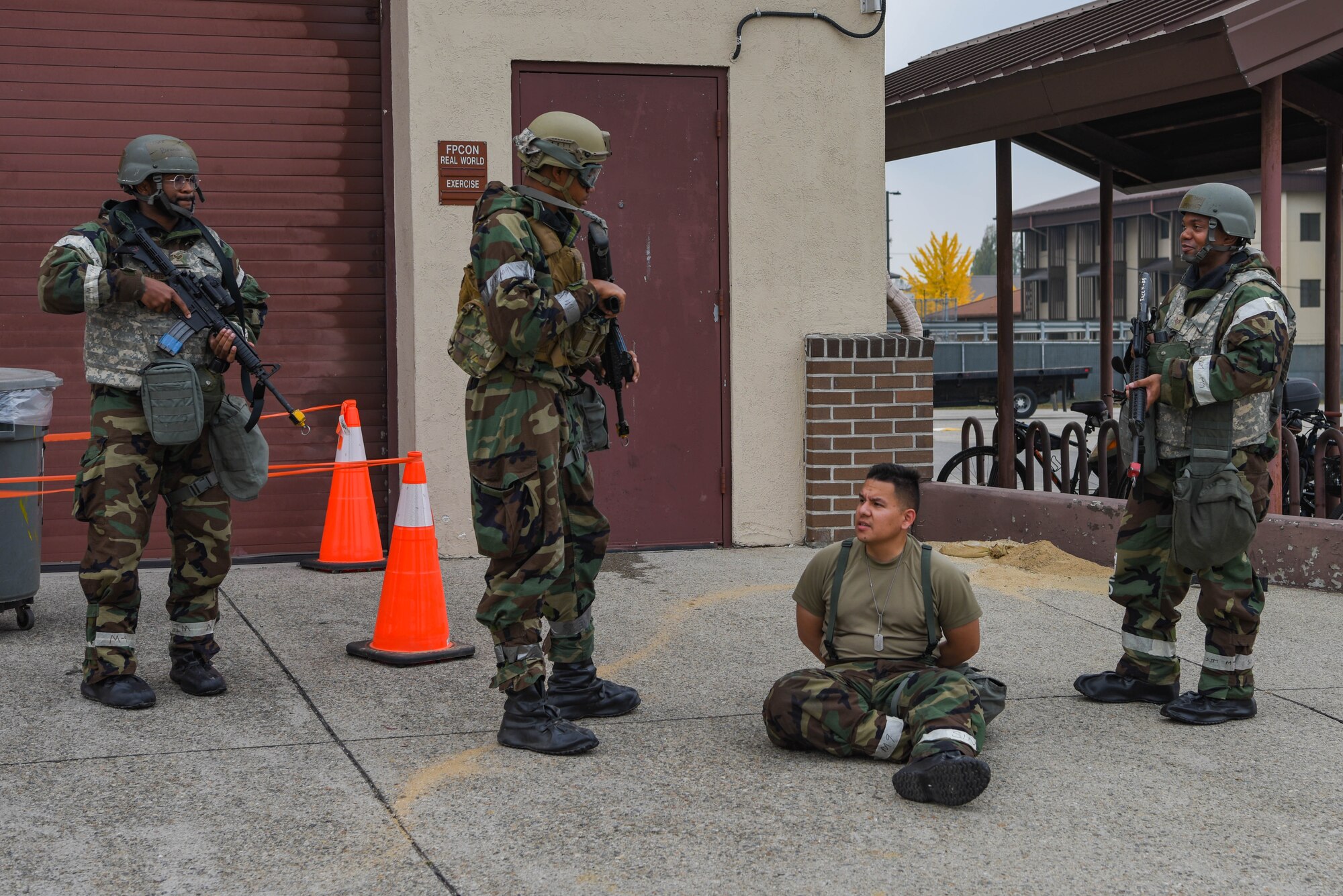 U.S. Air Force Airmen from the 51st Security Forces and Logistics Readiness Squadrons, simulate detainment procedures for a wing inspection team evaluation during Vigilant Defense 24 at Osan Air Base, Republic of Korea, Nov. 1, 2023. Responding to simulated threats prepares Airmen to maintain the level of readiness that allows Osan to execute the mission with consistency and precision in the event of a real world threat. VD24 is a routine training event that tests the military capabilities across the peninsula, allowing combined and joint training at both the operational and tactical levels. (U.S. Air Force photo by Airman 1st Class Chase Verzaal)