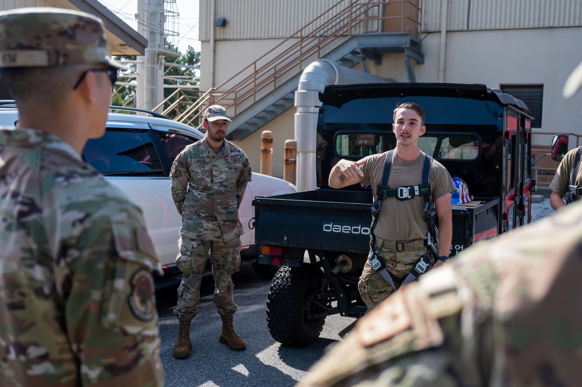 Senior Airman Jonathan Brinkey provides a briefing on beacon light replacement procedures before scaling a water tower.