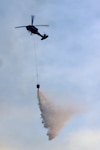 Virginia National Guard Soldiers assigned to the Sandston-based 2nd Battalion 224th Aviation Regiment, 29th Infantry, Division provide aerial fire suppression support Nov. 6, 2023, in Madison County. After Virginia Governor Glenn Youngkin declared a state of emergency, the VNG deployed two UH-60 Black Hawk helicopters equipped with 660-gallon water buckets at the request of the Virginia Department of Forestry.