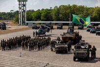 Brazilian soldiers stand alongside army equipment and vehicles during the opening ceremony for Exercise Southern Vanguard 24 in Macapa, Brazil, Nov. 6, 2023.