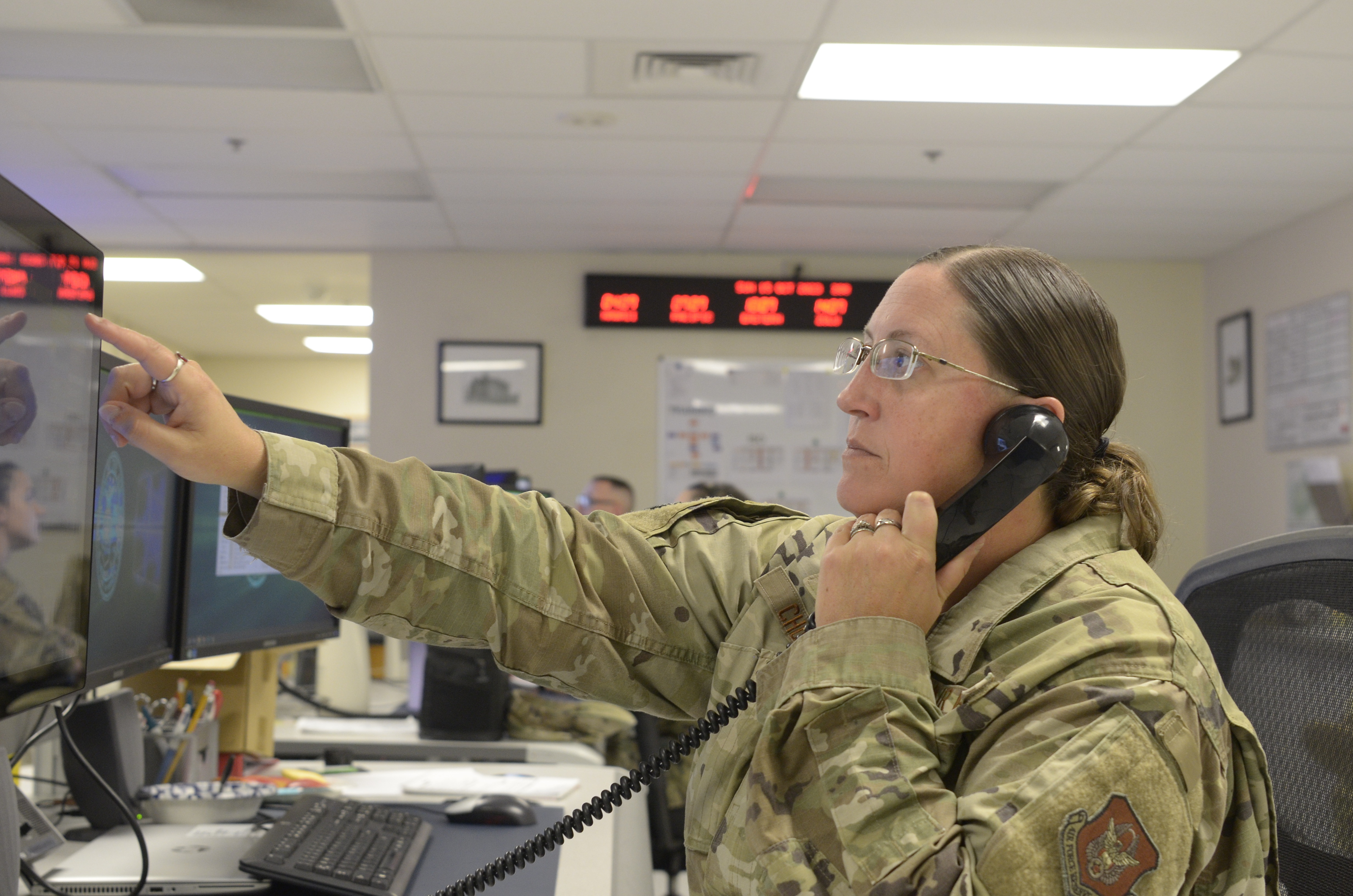 Master Sgt. Amber Church, 445th Airlift Wing Command Post superintendent, demonstrates the operation of command and control communications systems at Wright-Patterson Air Force Base, Ohio, Oct. 15, 2023. The Command Post relays communication, providing organizational and emergency services support for the safety and security of the nearly 1,700 Reserve Citizen Airmen throughout the wing. (U.S. Air Force photo/Staff Sgt. Ethan Spickler)