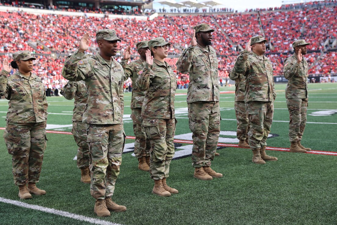 1st TSC Soldiers reenlist at the UofL Cardinals Salute to Service game