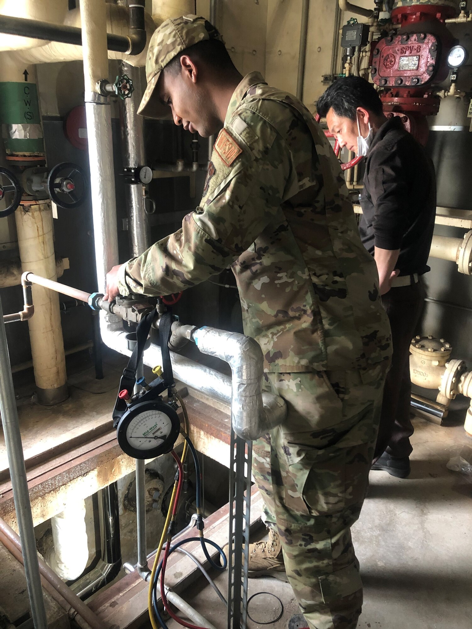 two people check a water system