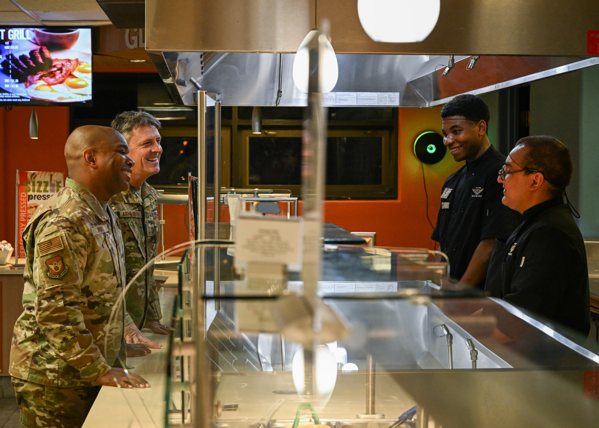 U.S. Air Force Maj. Gen. Jason R. Armagost, Eighth Air Force and Joint-Global Strike Operations Center commander, and Chief Master Sgt. Ronnie J. Woods, Eighth Air Force command chief, talk with Airmen assigned to the 5th Force Support Squadron during a base visit at Minot Air Force Base, North Dakota, Nov. 1, 2023. Armagost and Woods commended the Airmen for their contributions to Team Minot and fueling the mission of global deterrence. (U.S. Air Force photo by Airman 1st Class Kyle Wilson)
