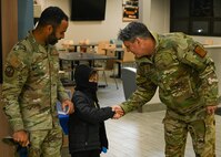 U.S. Air Force Maj. Gen. Jason R. Armagost, Eighth Air Force and Joint-Global Strike Operations Center commander, meets a family from Team Minot during a base visit at Minot Air Force Base, North Dakota, Nov. 1, 2023. During the visit, Armagost interacted with members of Team Minot and gained a deeper understanding of how they execute the global deterrence mission. (U.S. Air Force photo by Airman 1st Class Kyle Wilson)