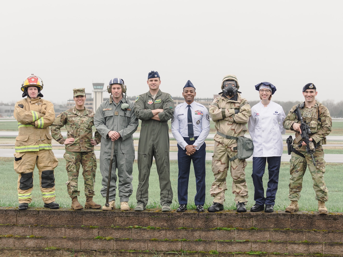 Photo of Members of the Vermont Air National Guard standing in front of the Burlington International Airport, South Burlington, Vt. April 28, 2022. The members represent various Air Force Specialty Codes (AFSCs), or jobs, available in the Vermont Air National Guard. (US Air Force photo by Senior Master Sgt. Michael Davis)