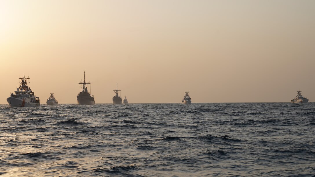 GULF OF OMAN (Nov. 3, 2023) Five U.S. Coast Guard Sentinel-class fast-response cutters and two Avenger-class mine countermeasures (MCM) ships sail together in the Gulf of Oman, Nov. 3. The cutters are assigned to Patrol Forces Southwest Asia (PATFORSWA), the Coast Guard's largest unit outside of the U.S. The MCMs are assigned to Task Force 52, responsible for U.S. 5th Fleet's mine countermeasures mission. These units enhance maritime security and deter malign activity in this vital region and through strategic chokepoints such as the Strait of Hormuz. (U.S. Navy courtesy photo)