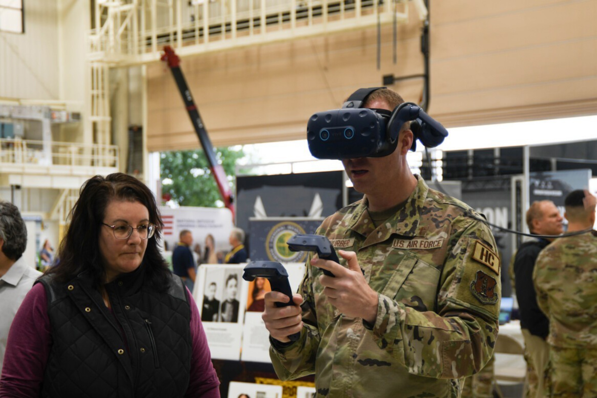 The U.S. Army Combat Capabilities Development Command Soldier Center, or DEVCOM SC, recently participated in a STEM Exploration Open House hosted by the Rhode Island National Guard at the Quonset National Guard Base in North Kingstown, Rhode Island. DEVCOM SC’s Christina Caruso looks on as a STEM event participant tries out Augmented Reality/Virtual Reality capabilities.