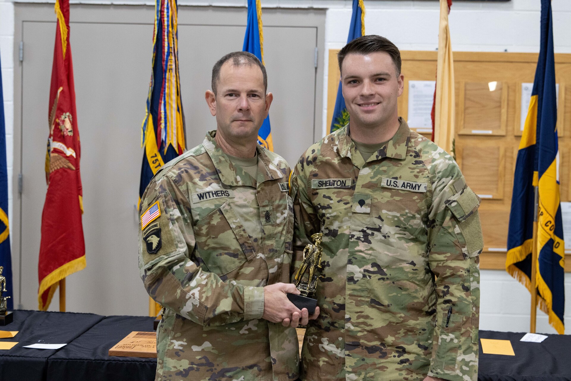 Spc. Stephen Shelton receives the Runner-Up for Soldier of the Year trophy from Kentucky National Guard State Command Sgt. Maj. Jesse Withers during a ceremony at the conclusion of the 2023 Kentucky Best Warrior Competition at Wendell H. Ford Regional Training Center, Greenville, Kentucky, November 5, 2023. Sgt. Robert Buck and Spc. Jackie Zheng received NCO of the Year and Soldier of the Year. (U.S. Army National Guard photo by Capt. Cody Stagner)
