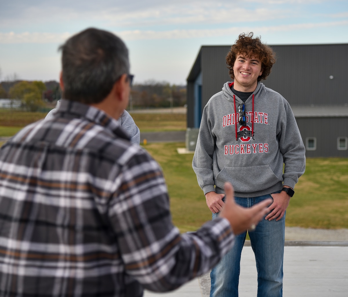 Henry Kitchen, Ohio State University aerospace engineering sophomore, listens to Hank Griffiths, AFWERX chief of test and airworthiness, talk about Advanced Air Mobility at the Springfield-Beckley Municipal Airport, Ohio, Nov. 7, 2023. (U.S. Air Force photo by Matthew Clouse)