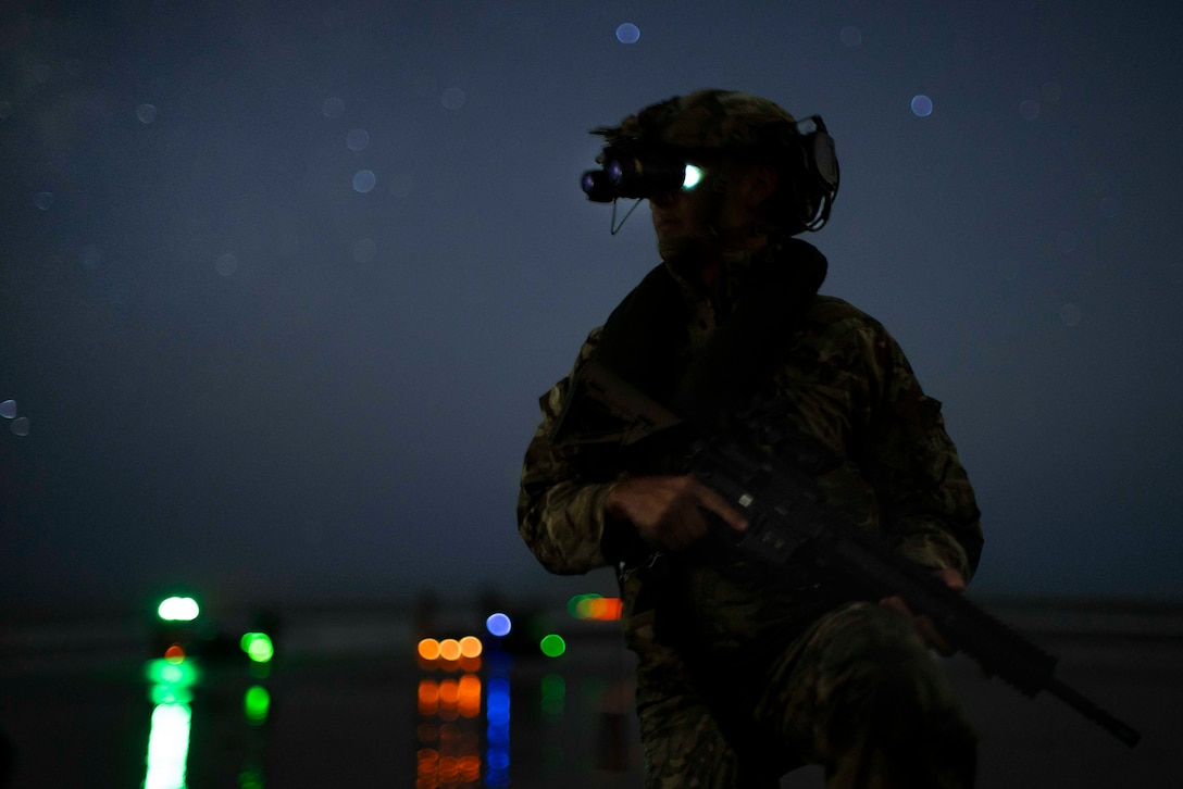 A British Royal Marine Commando assigned to 40 Commando, currently attached to the 15th Marine Expeditionary Unit, holds security on a beach during night small boat training with Reconnaissance Company, 15th MEU, at Marine Corps Base Camp Pendleton, California, Oct. 4, 2023. Utilizing small boats to conduct a low-light amphibious landing permits Reconnaissance Company Marines to locate, approach, seize and hold key maritime terrain, and conduct reconnaissance and counter-reconnaissance under the cover of darkness. (U.S. Marine Corps photo by Sgt. Patrick Katz)
