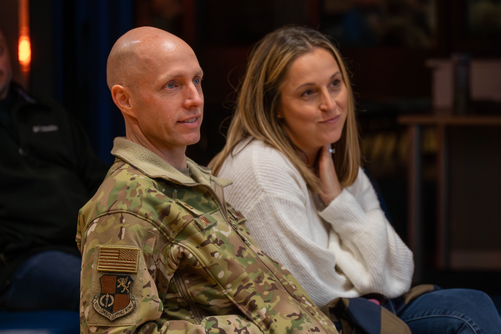 Audience members listen and smile during brief.