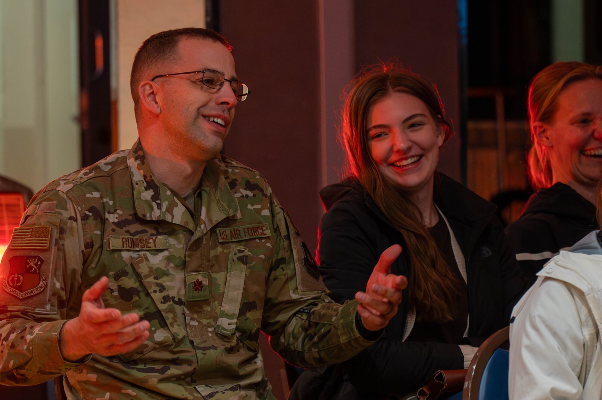 Participants smile while sitting during a town hall.