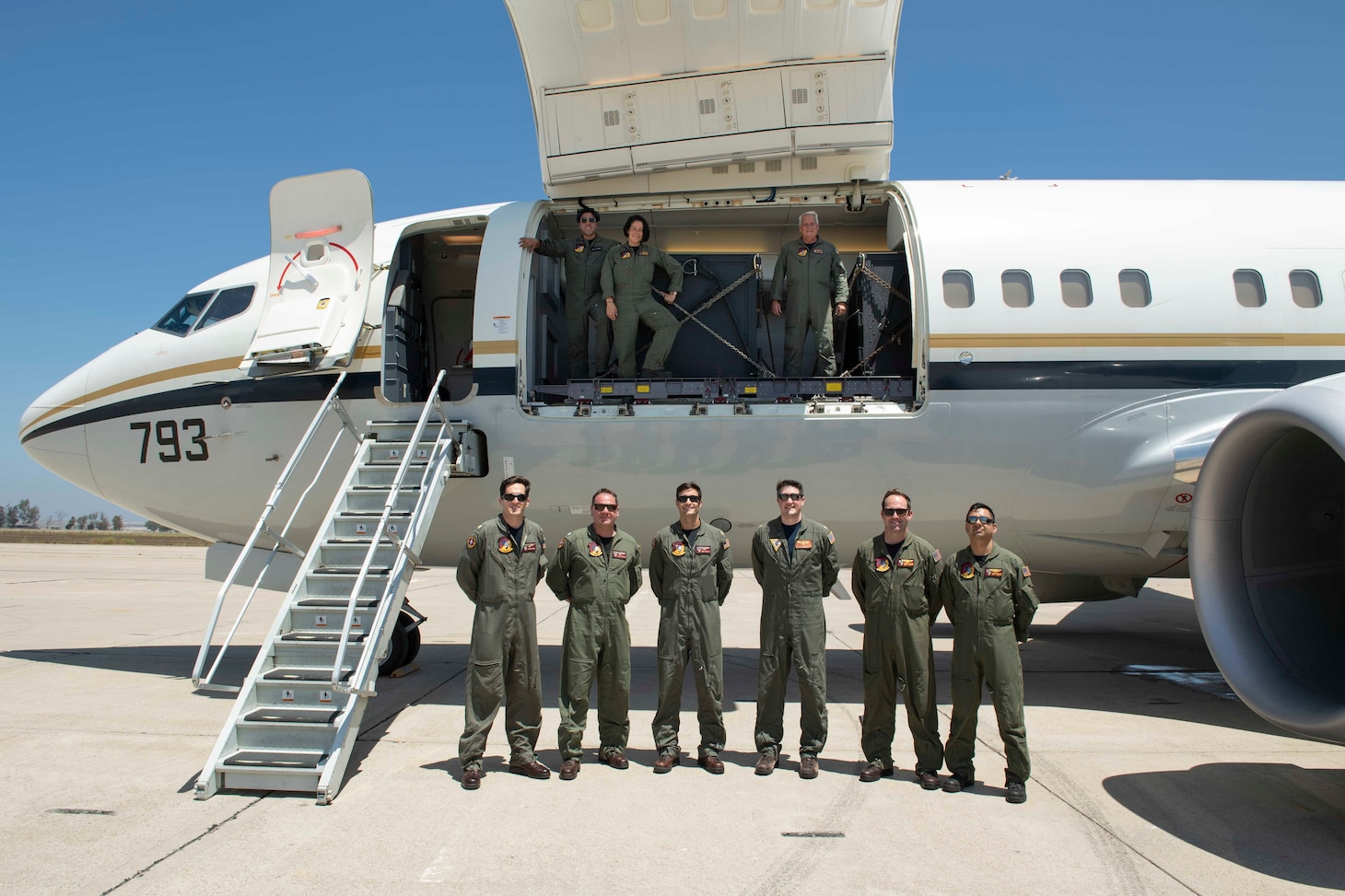 Sailors assigned to the "Conquistadors" of Fleet Logistics Support Squadron (VR) 57 pose for a group photo with the squadron's C-40 Clipper at Brown Field Municipal Airport