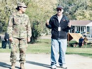 Illinois State Military Museum volunteer Richard Schachtsiek of Springfield explains the advancements in the modern Army uniform from World War I with Illinois Army National Guard Cpl. Marina Lopez-Melgoza serving as a model.