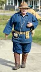 Illinois State Military Museum volunteer John Werner of Chatham, Illinois, explains how the World War I uniform he is wearing found a new use in World War II when the U.S. used it as the uniform for enemy prisoners of war.