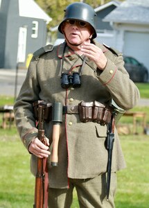 Illinois State Military Museum volunteer Bjorn Ganger of Tonica, Illinois, portrays a  World War I German Infantry Soldier. He is explaining how the Germans were more advanced in gas warfare using a gas mask with charcoal filters as opposed to just cloth in the Allied gas masks.