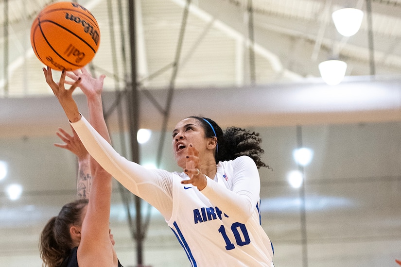 An airman shoots a basketball.