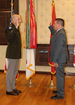 A man administers an oath to another man.