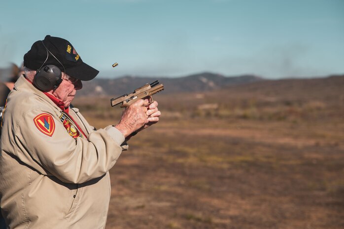 U.S. Marine Corps veteran Cpl. Don Graves fires an M45A1 pistol at Marine Corps Base Camp Pendleton, California, Nov. 1, 2023. Graves, a distinguished WWII veteran who served with the 2nd Battalion, 28th Marine Regiment at Iwo Jima, visited Marine Corps Recruit Depot San Diego to observe training and interact with the Marines. (U.S. Marine Corps photo by Sgt. Sydney Smith)