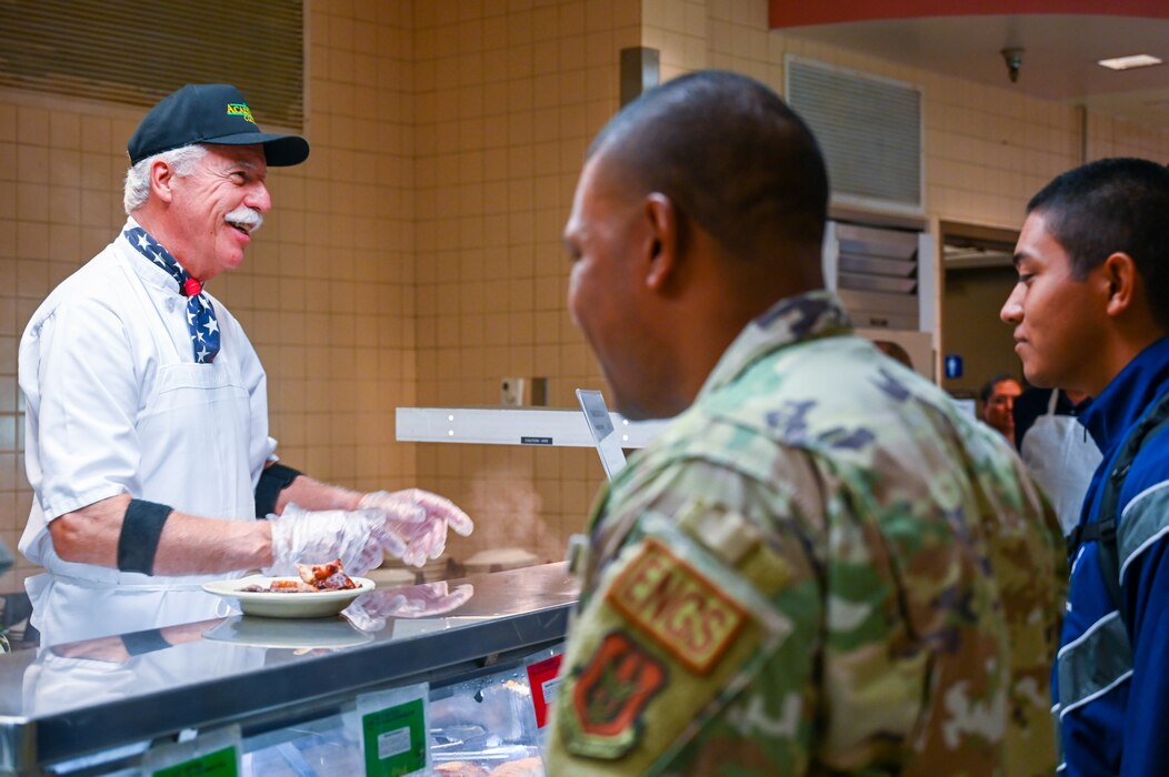 Dave Saylor, 433rd Airlift Wing Honorary Commander alumnus, greets Airmen at the Live Oak Dining Facility during the “Feed the Airmen” Luncheon event at Joint Base San Antonio-Lackland, Texas, Nov. 4, 2023.