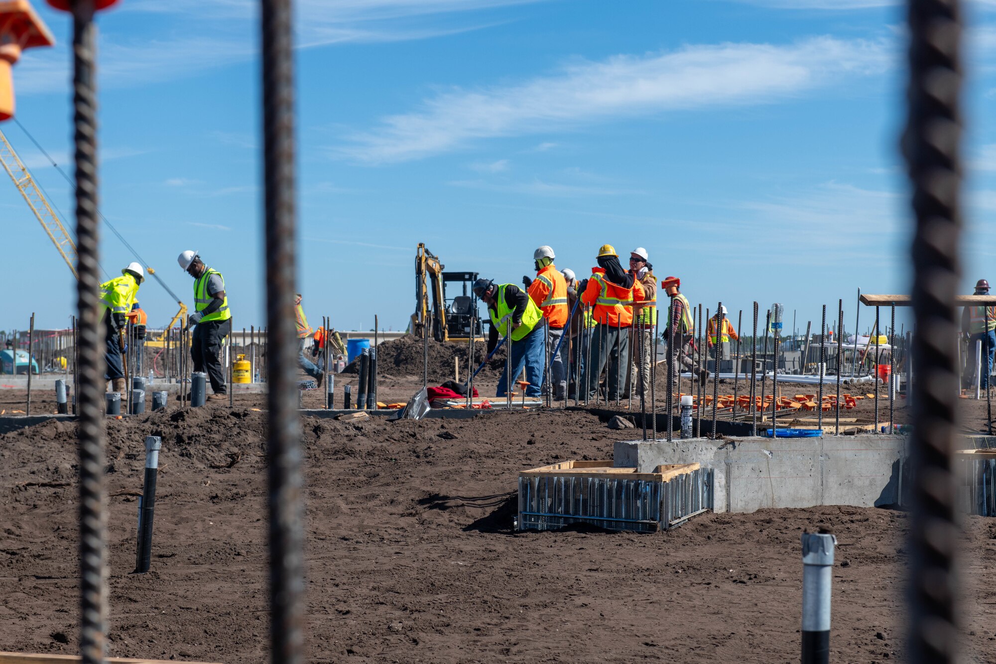 A group of construction workers can be seen working on a construction site.