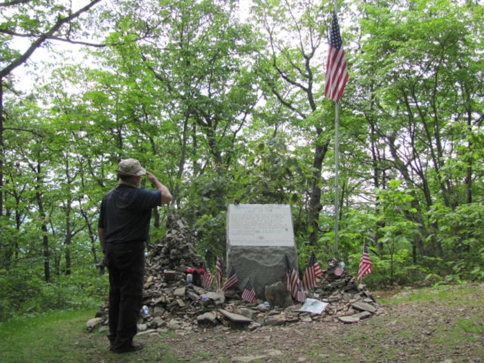 Rob Ligas, a retired Airman who works for the 88th Civil Engineer Squadron at Wright-Patterson Air Force Base, Ohio, salutes the Audie Murphy Monument in the Shenandoah Valley near New Castle, Virginia, during his Appalachian Trail hike June 1, 2017. Murphy, the most decorated U.S. Soldier in World War II, died in a May 1971 airplane crash near the memorial site. (Contributed photo)