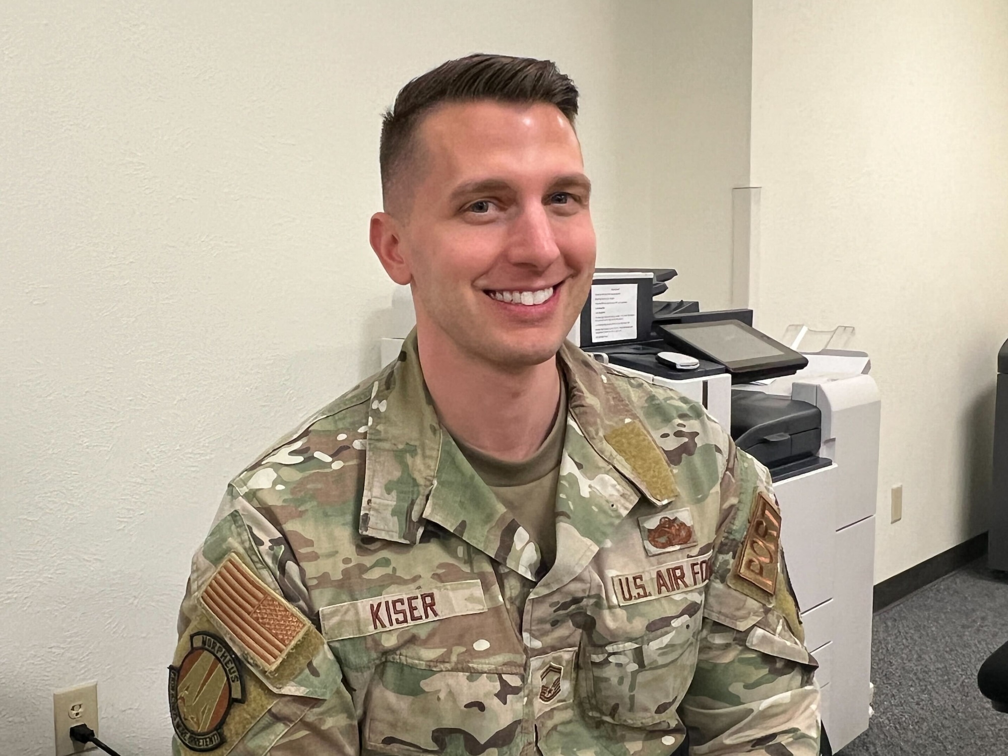 An Airman smiles at the camera.
